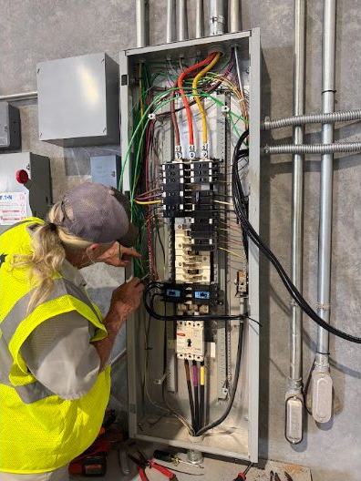 Texan Electric technician working at an electrical panel